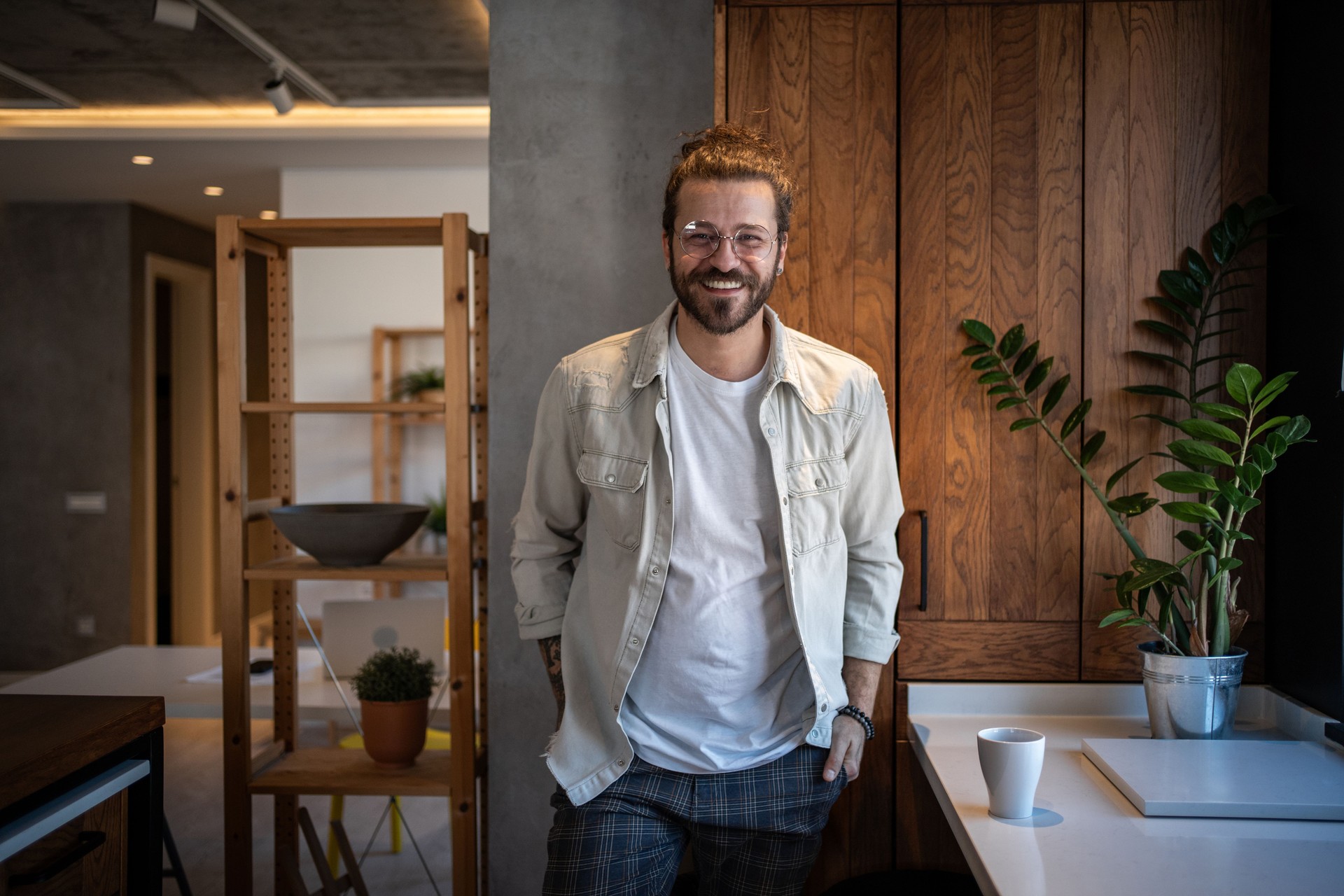 Young man smiling in modern designed home office
